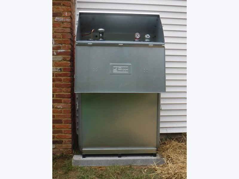 Roth double-wall oil tank installed outdoors on a concrete pad with top fittings visible