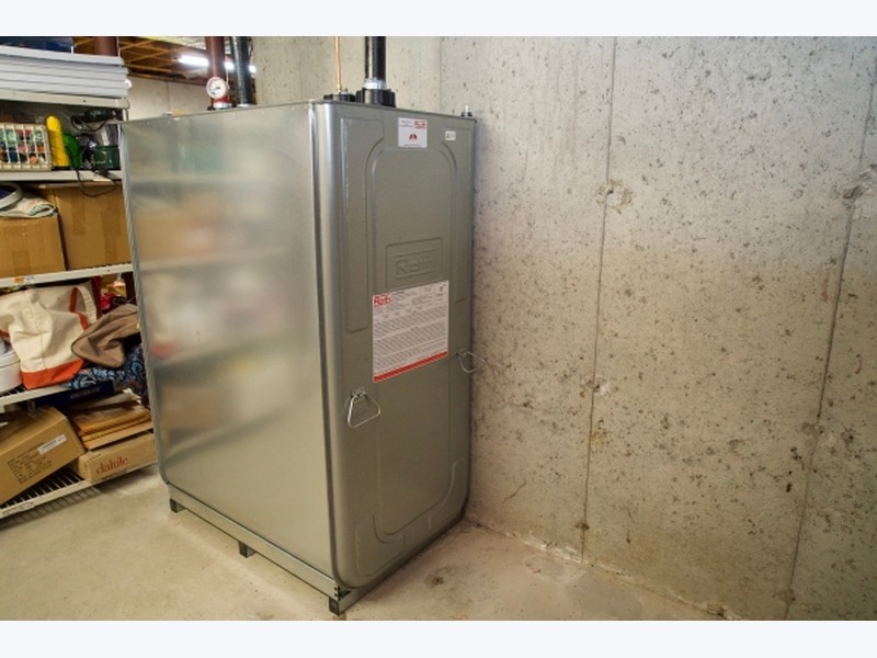 Roth 400-gallon double-wall oil tank installed in a basement corner