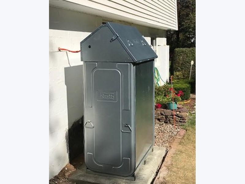 Roth double-wall oil tank with weather cap installed outside a Long Island home